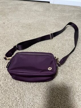 lululemon athletica Deep Plum Crossbody Bag with Gold Hardware